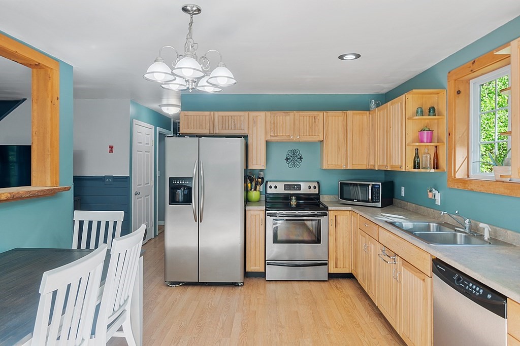 540 Royalston Road Phillipston, MA 01331 - Photo 13 of 38 a kitchen with stainless steel appliances a refrigerator a sink a stove a microwave and island