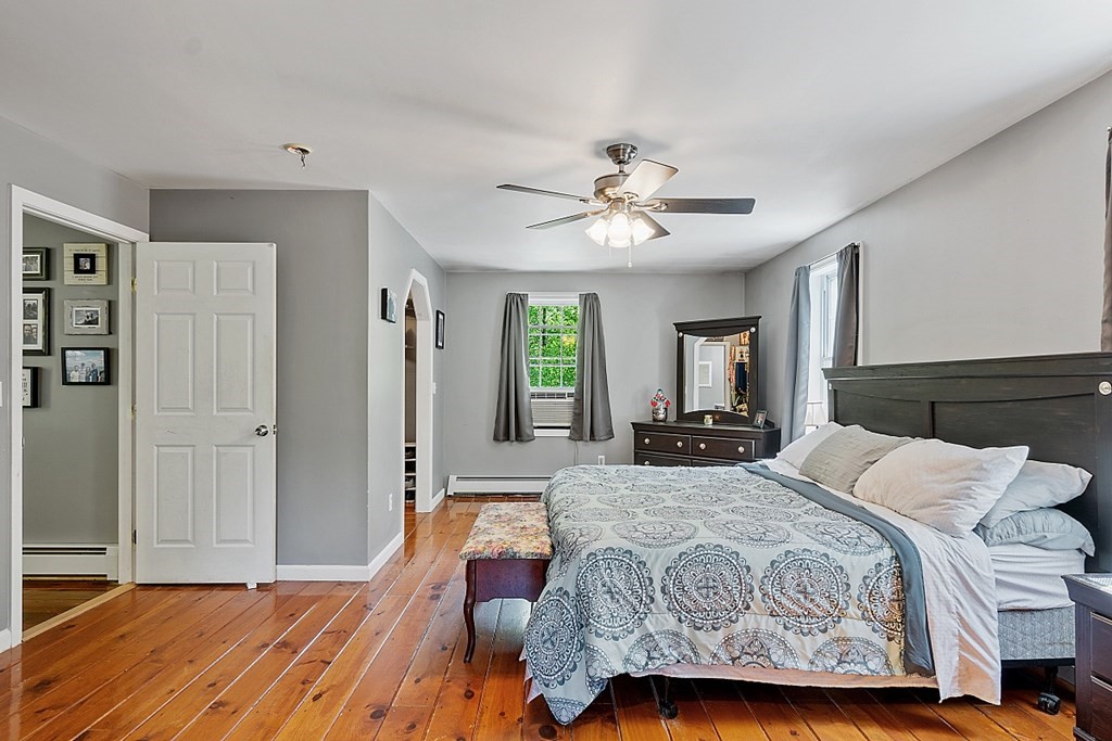 540 Royalston Road Phillipston, MA 01331 - Photo 28 of 38 a bedroom with a large bed a chandelier and dresser