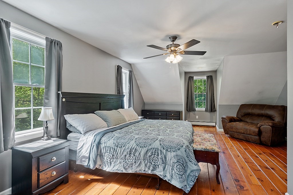 540 Royalston Road Phillipston, MA 01331 - Photo 31 of 38 a bedroom with a bed chandelier and a window