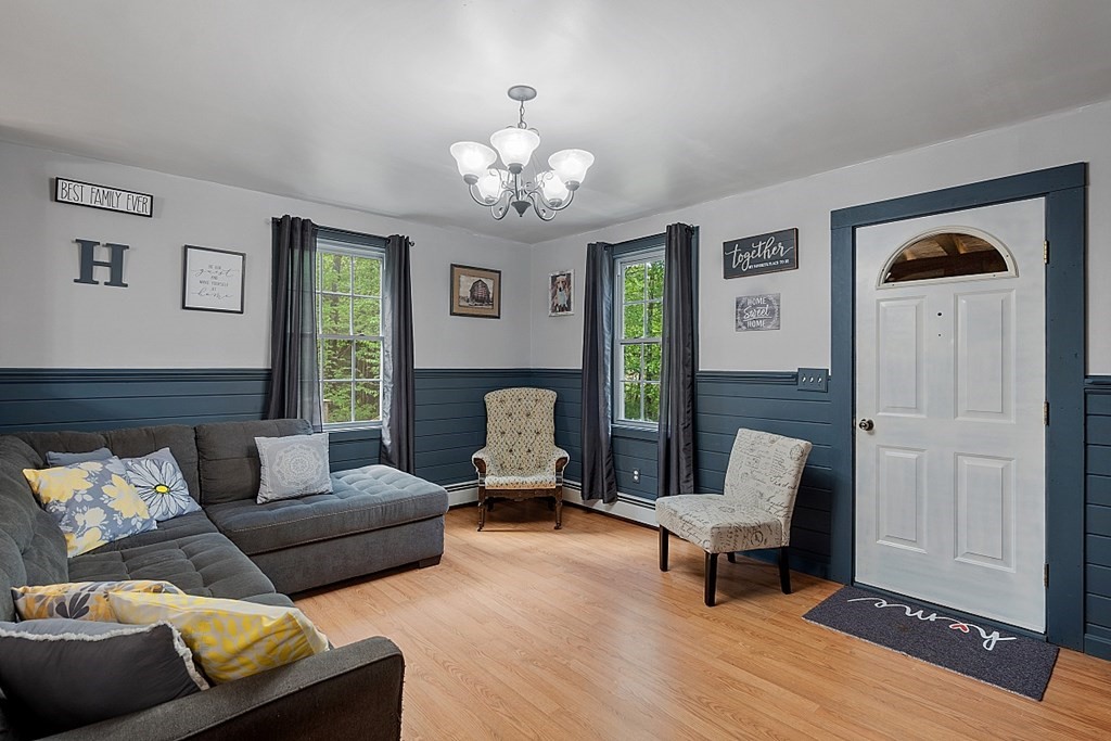 540 Royalston Road Phillipston, MA 01331 - Photo 7 of 38 a living room with furniture a chandelier and a window