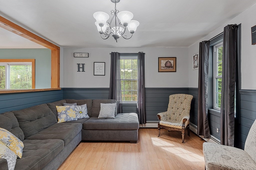 540 Royalston Road Phillipston, MA 01331 - Photo 8 of 38 a living room with furniture and a chandelier