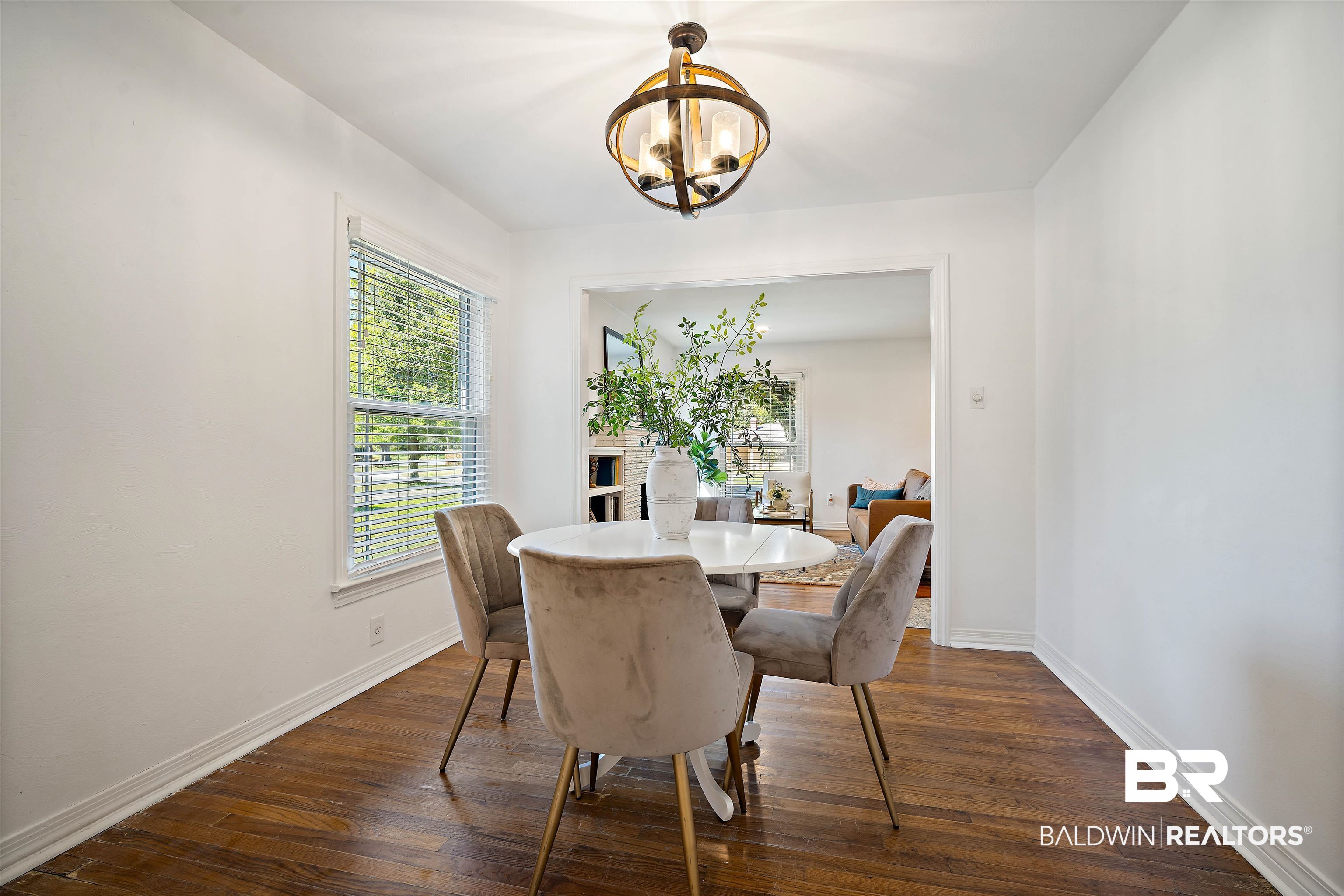 2615 Walton Avenue Mobile, AL 36606 - Photo 18 of 33 Dining space with dark wood-style floors, baseboards, and a notable chandelier
