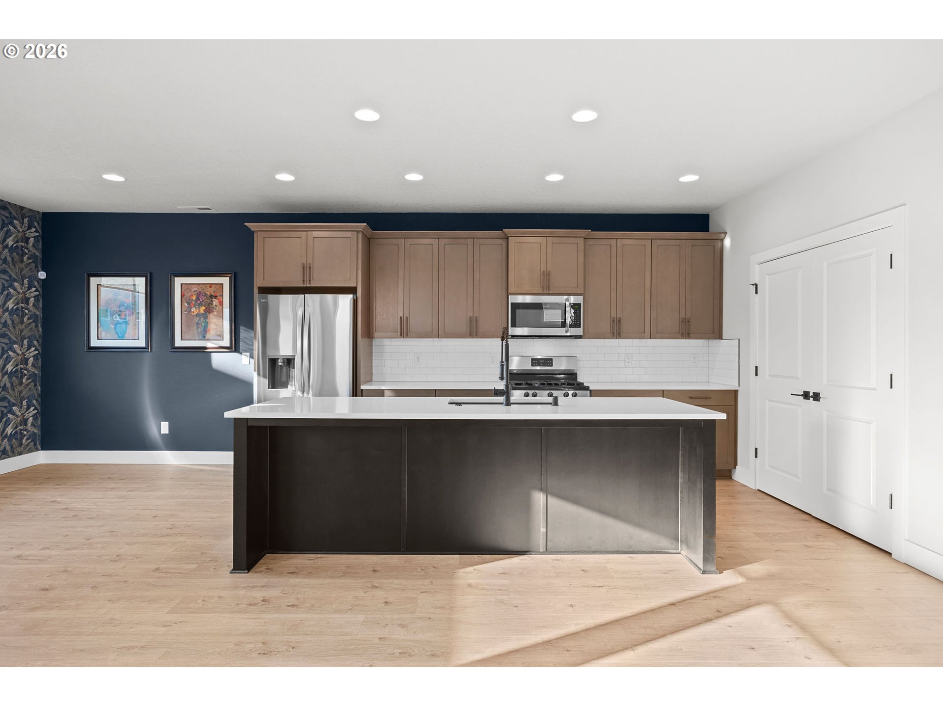 719 Northwest 178th Street Ridgefield, WA 98642 - Photo 11 of 46 a living room with stainless steel appliances kitchen island a cabinets and wooden floor