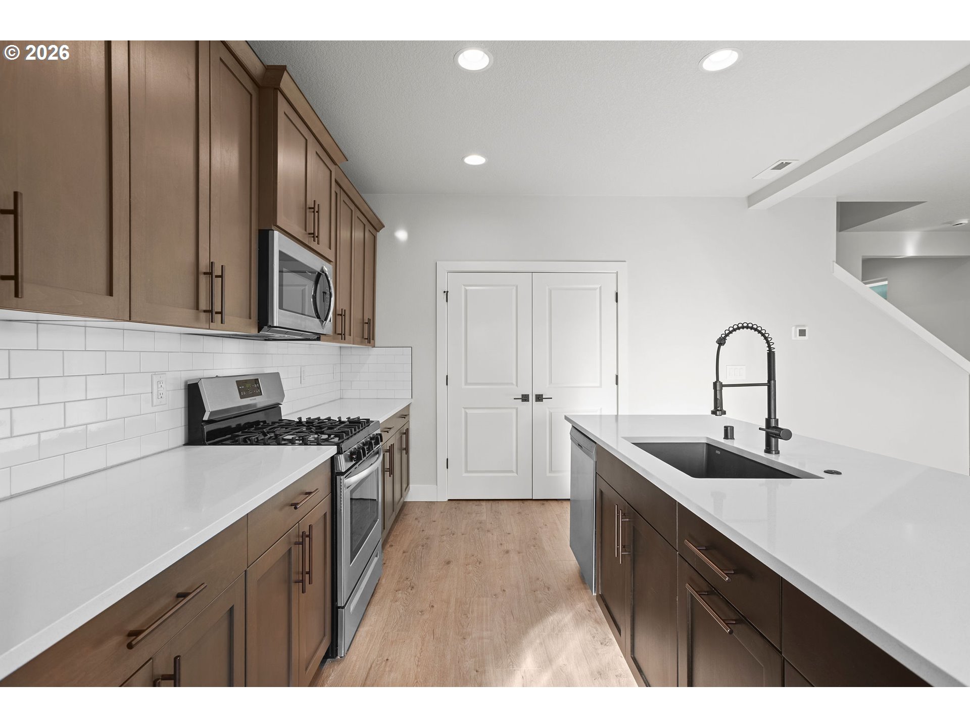 719 Northwest 178th Street Ridgefield, WA 98642 - Photo 16 of 46 a kitchen with a sink and cabinets