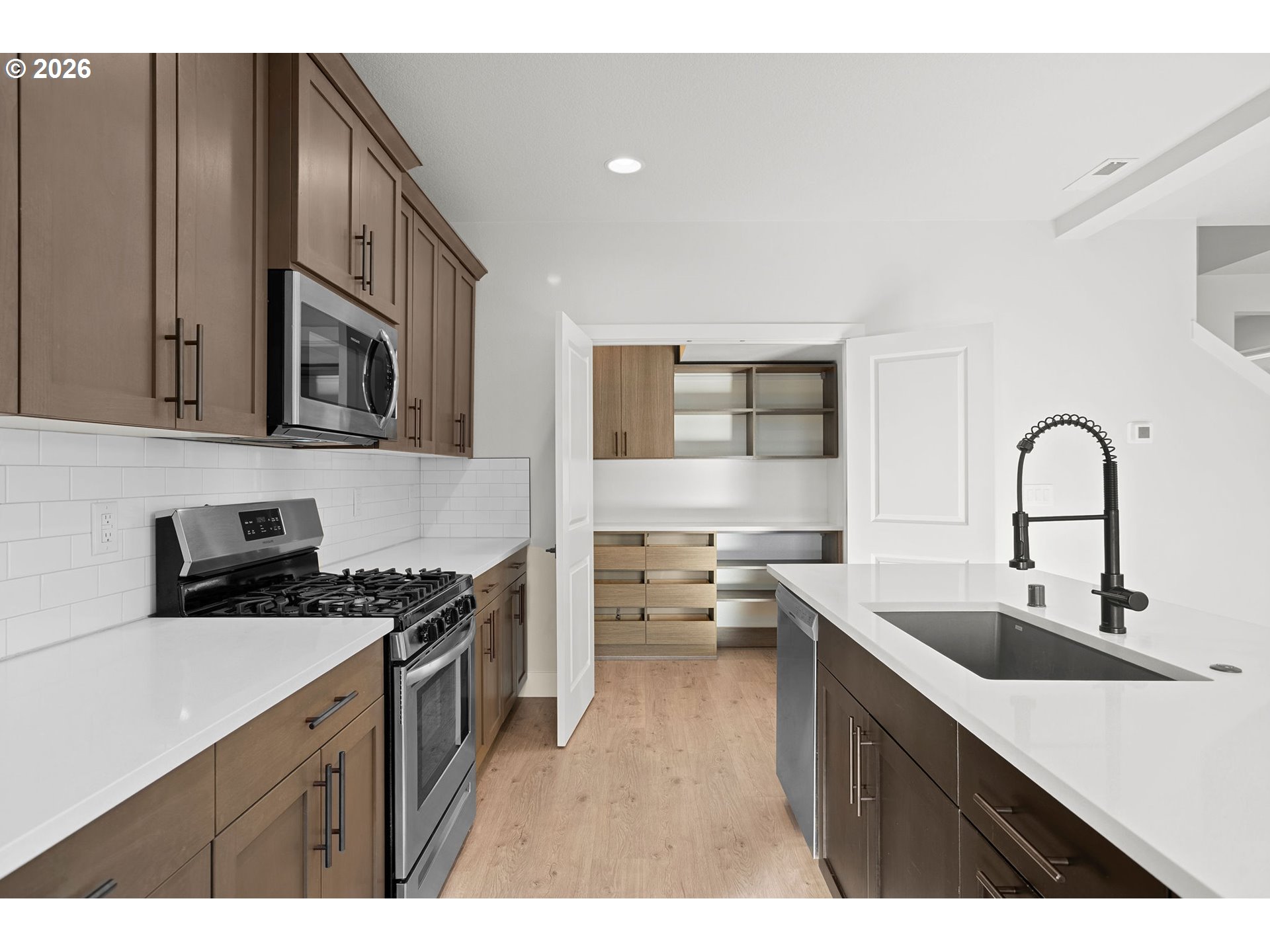 719 Northwest 178th Street Ridgefield, WA 98642 - Photo 17 of 46 a kitchen with stainless steel appliances a sink stove and cabinets