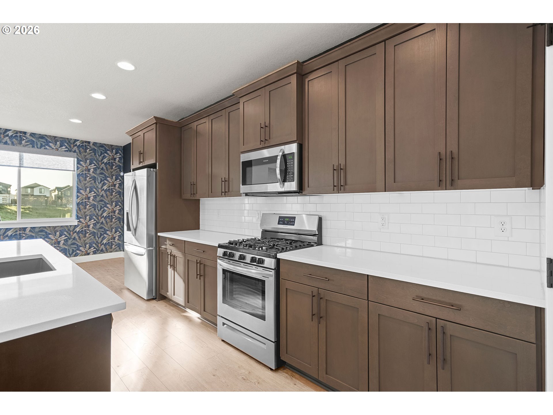 719 Northwest 178th Street Ridgefield, WA 98642 - Photo 19 of 46 a kitchen with a refrigerator stove and sink