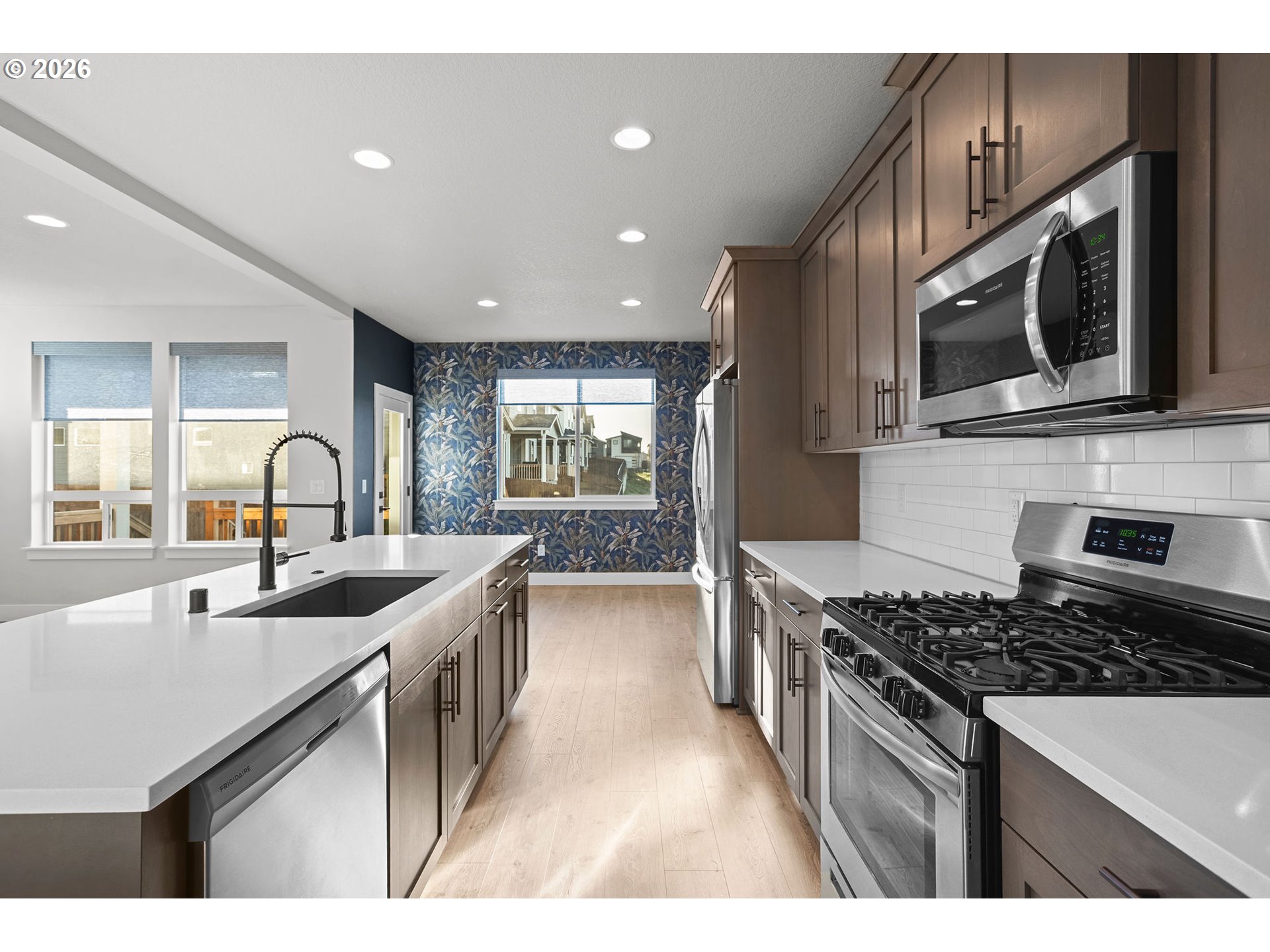 719 Northwest 178th Street Ridgefield, WA 98642 - Photo 20 of 46 a kitchen with stainless steel appliances granite countertop a sink stove and cabinets