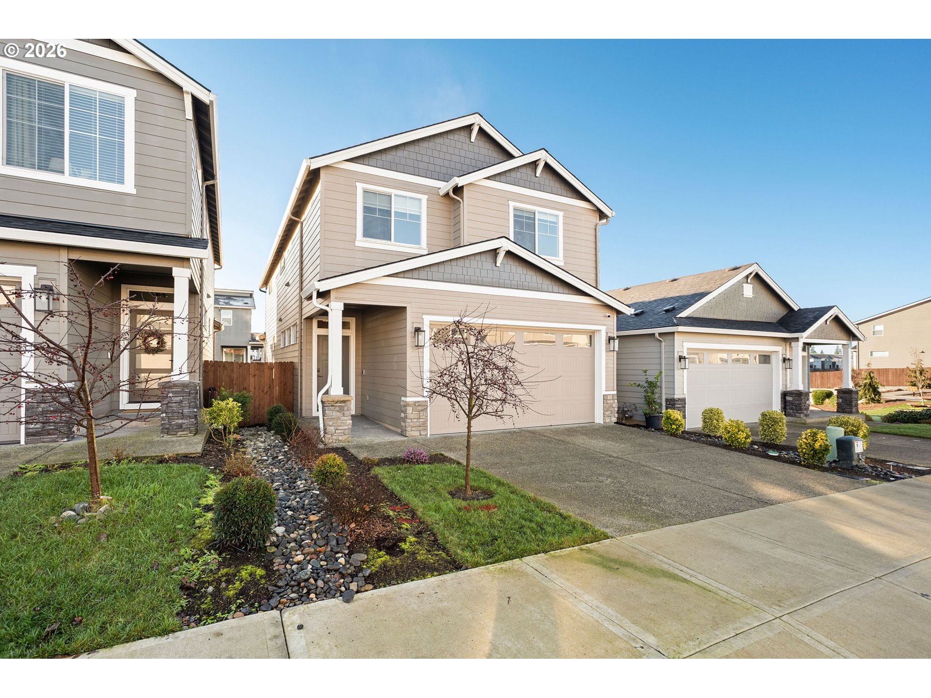 719 Northwest 178th Street Ridgefield, WA 98642 - Photo 2 of 46 a front view of a house with a yard and garage