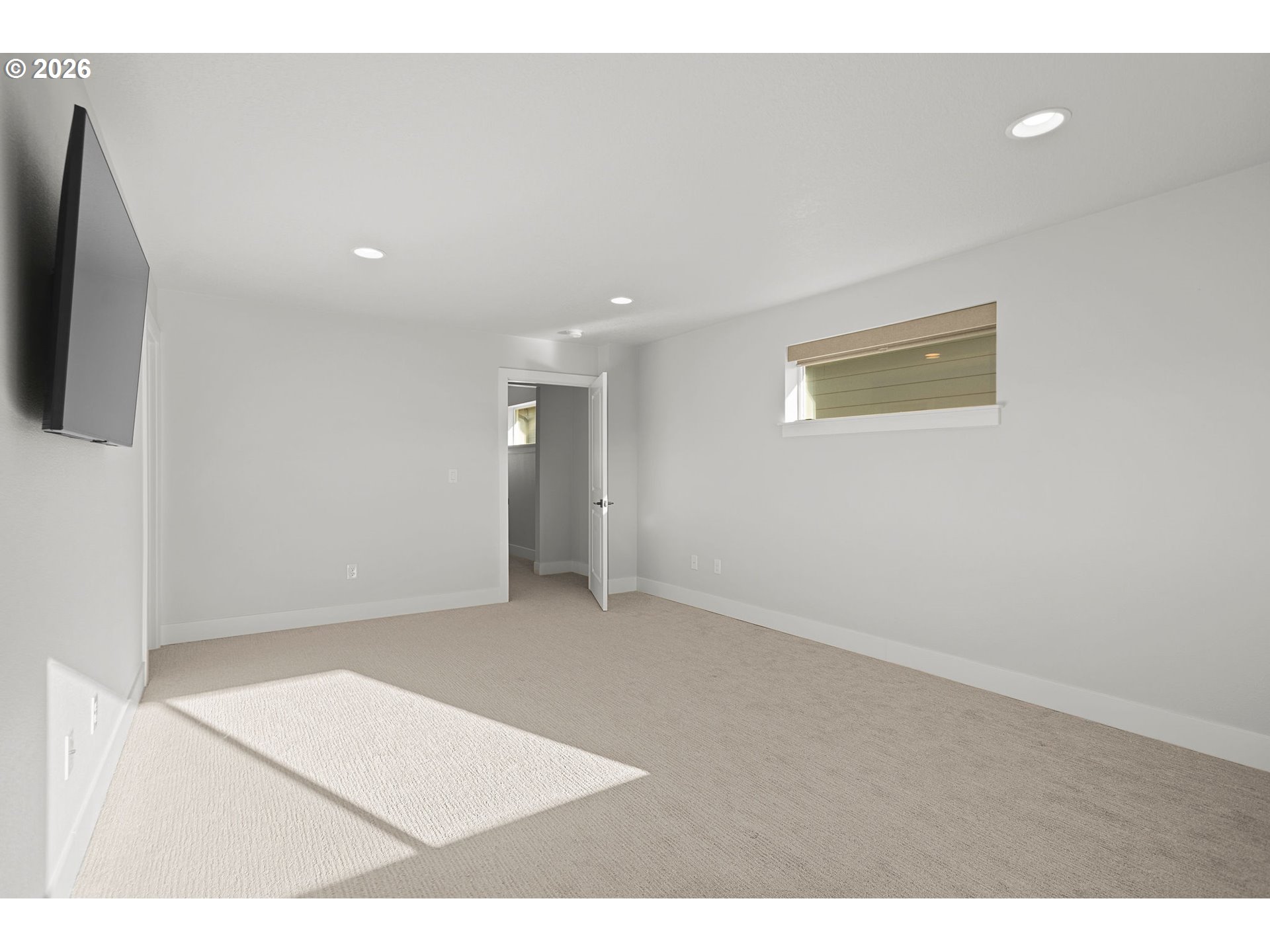 719 Northwest 178th Street Ridgefield, WA 98642 - Photo 31 of 46 a view of an empty room with a flat screen tv