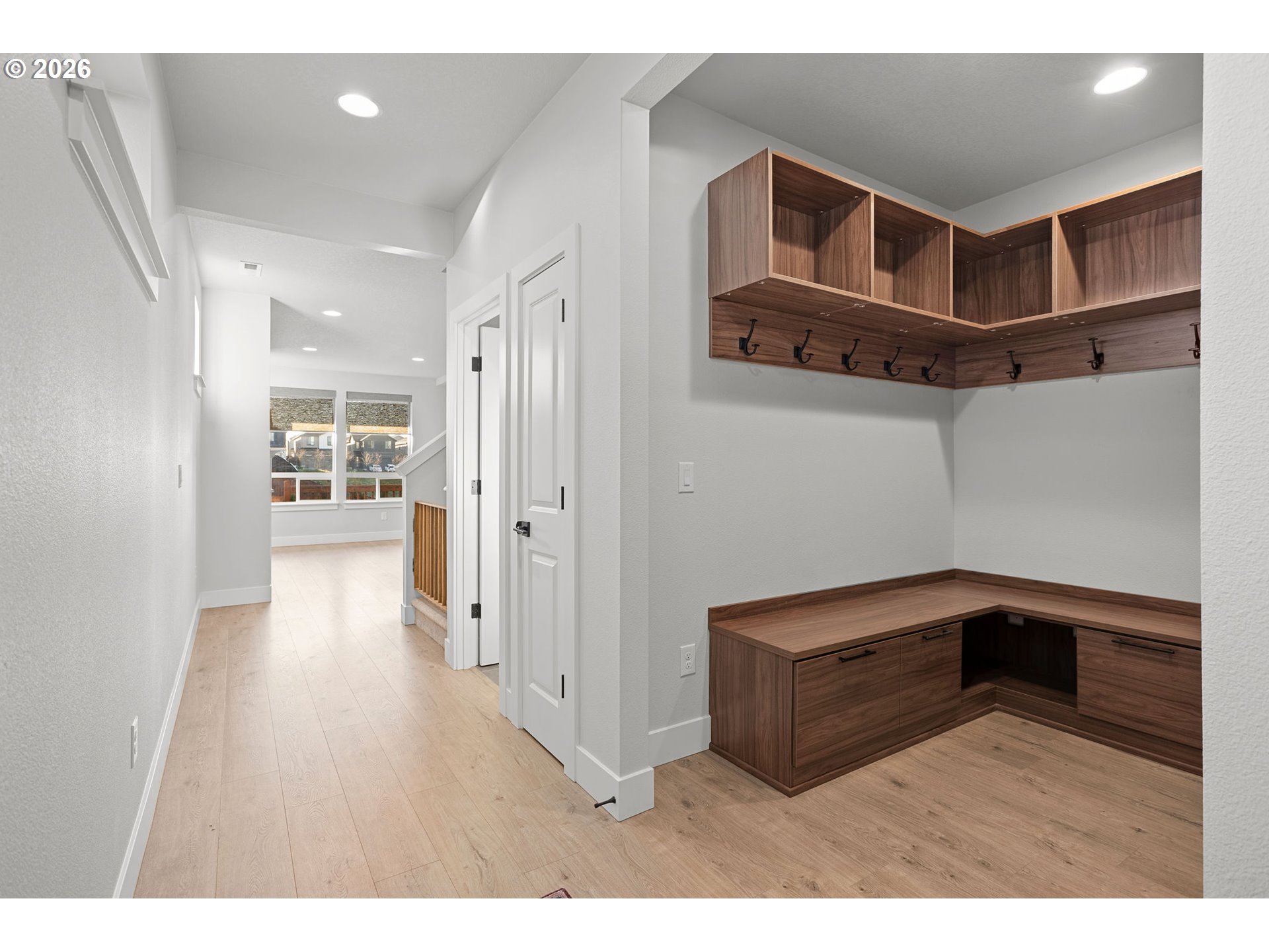 719 Northwest 178th Street Ridgefield, WA 98642 - Photo 4 of 46 a hallway view with wooden cabinets and entryway
