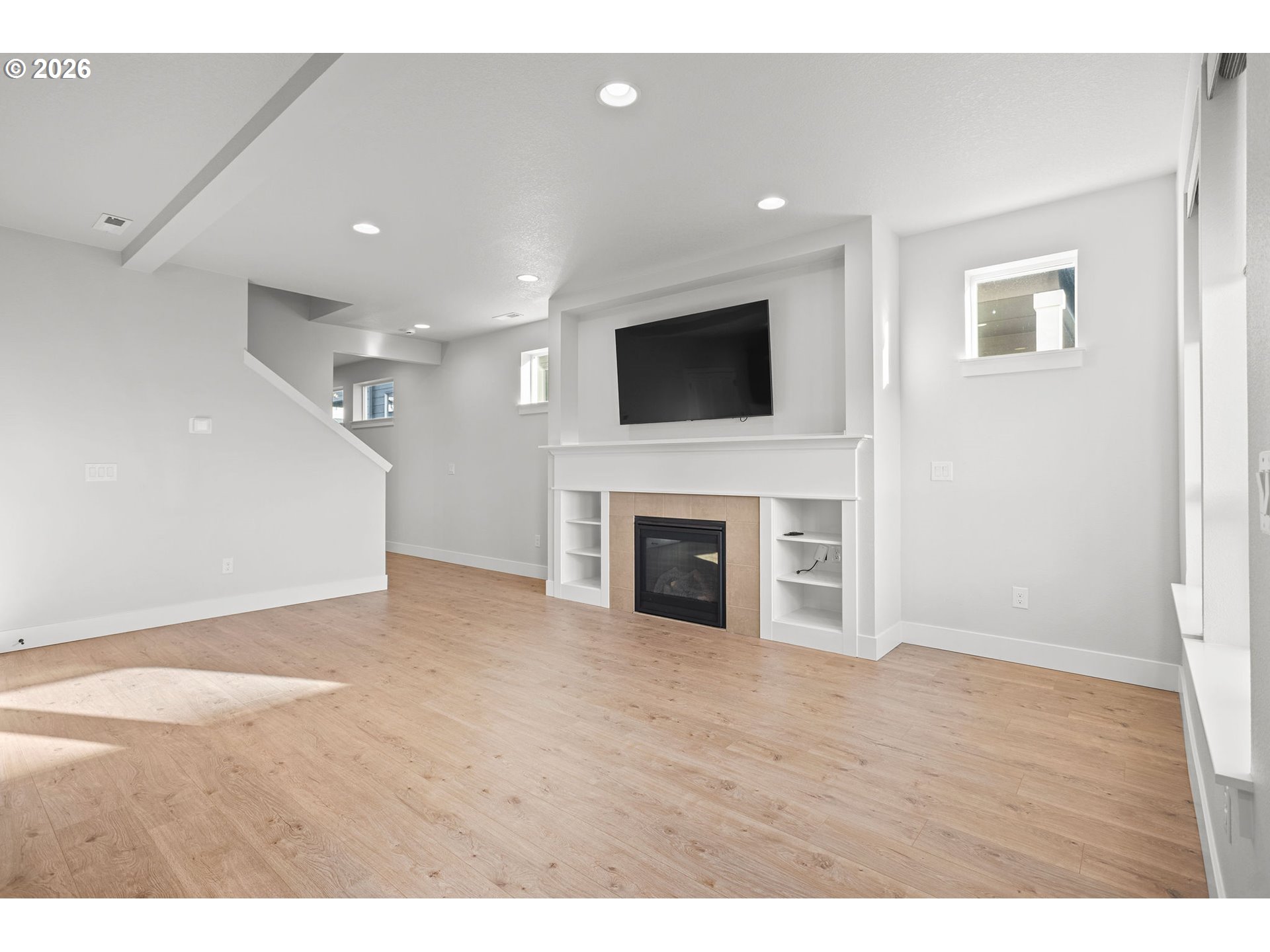 719 Northwest 178th Street Ridgefield, WA 98642 - Photo 8 of 46 a view of a livingroom with a flat screen tv and fireplace