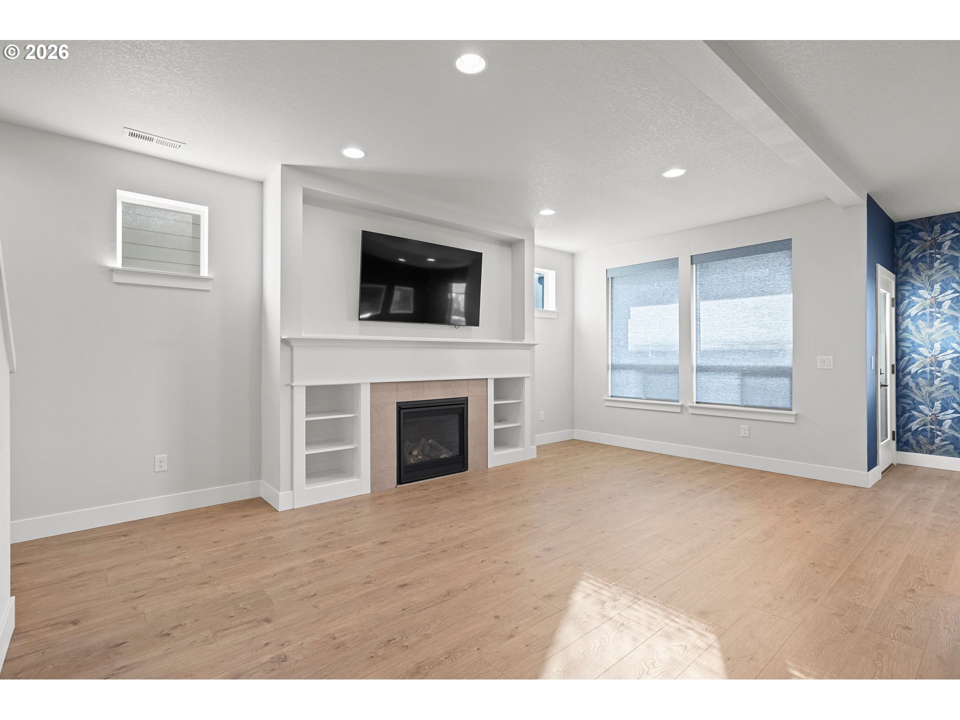 719 Northwest 178th Street Ridgefield, WA 98642 - Photo 9 of 46 a view of empty room with fireplace and fan