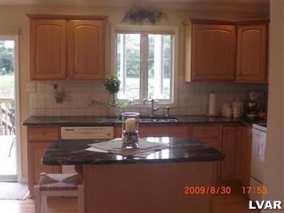 1585 Deer Path Road Easton, PA 18040 - Photo 3 of 28 Overhang for stools. Tile backsplash.
