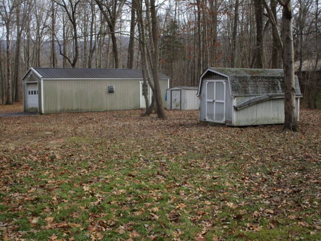 2160 Mt Torrey Road Lyndhurst, VA 22952 - Photo 16 of 16 a view of a barn in the backyard with large tree and deck