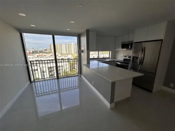 a view of a kitchen with a refrigerator a window