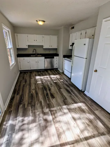 a view of kitchen with wooden floor