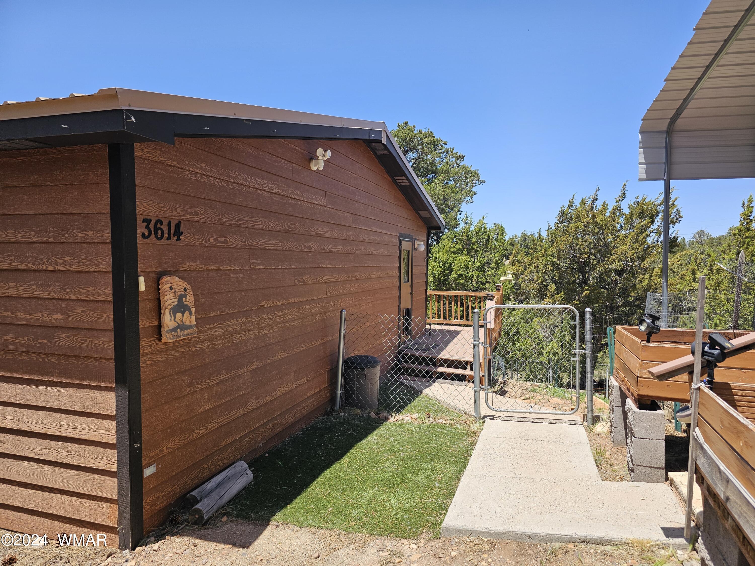 2896 Pine Rim Road Overgaard, AZ 85933 - Photo 7 of 17 a backyard of a house with table and chairs