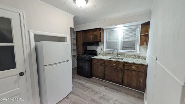 a kitchen with a refrigerator and a sink