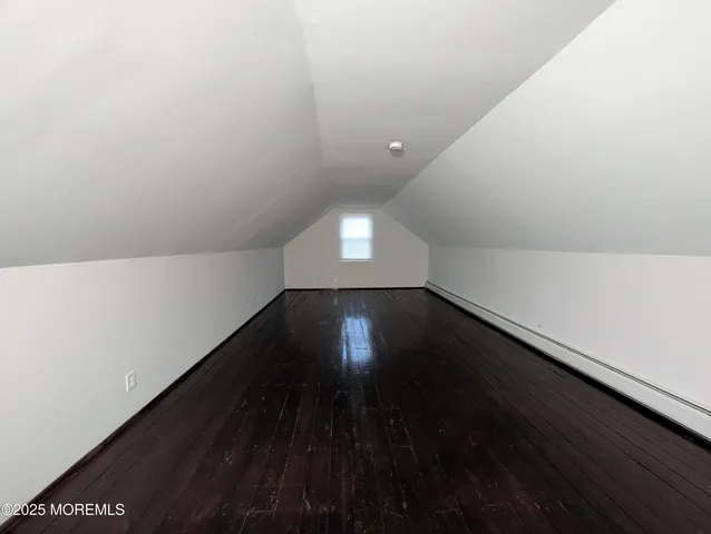 a view of room with wooden floor and windows