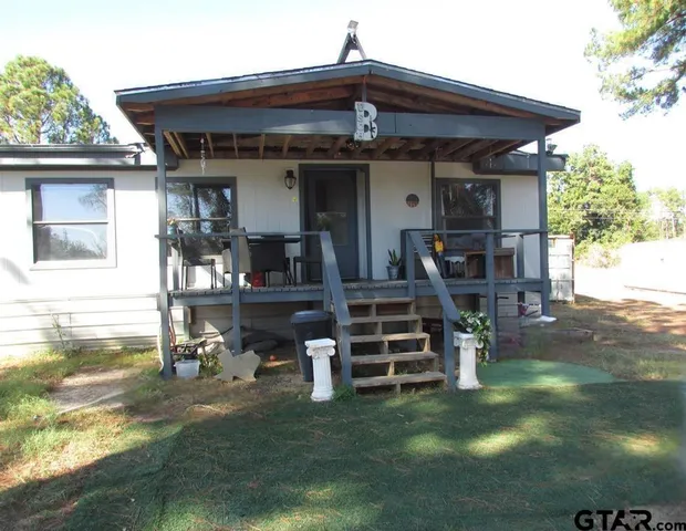 a view of a house with backyard porch and sitting area