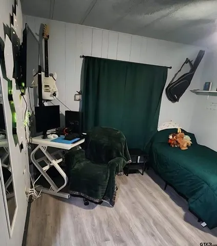 a living room with patio furniture and a flat screen tv