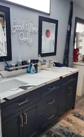 a bathroom with a sink and a mirror