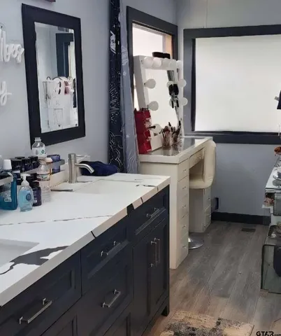 a bathroom with a sink vanity and mirror
