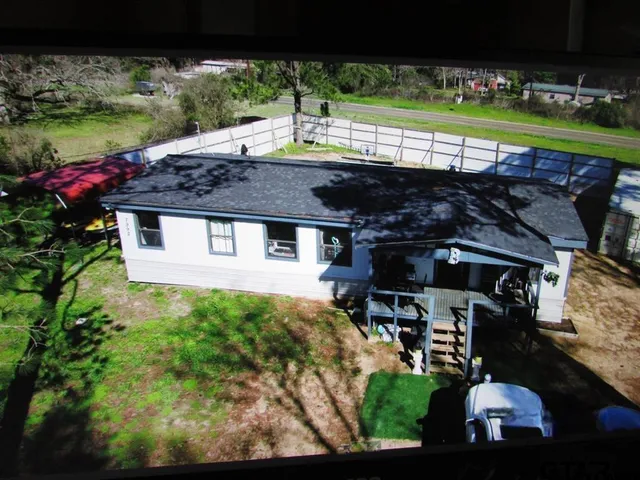 a view of a patio with table and chairs and potted plants