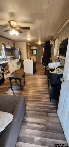 a living room with lots of furniture and a flat screen tv