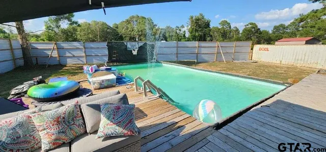 a view of a backyard with sitting area