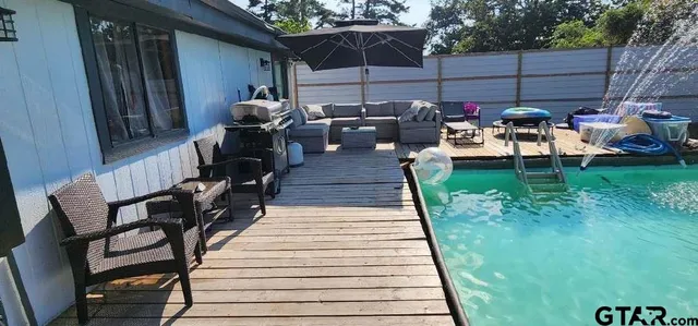 a view of a patio with lawn chairs next to a yard