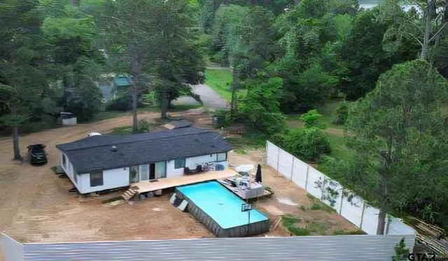 a view of yard from deck with patio
