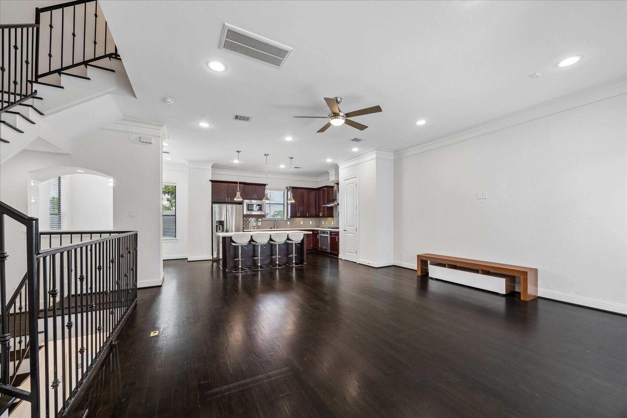 734 West 20th Street, Unit A Houston, TX 77008 - Photo 8 of 23 Wide, flexible living space offers multiple layout options, enhanced by iron railing detail, crown molding & a seamless connection to the kitchen for effortless everyday living.