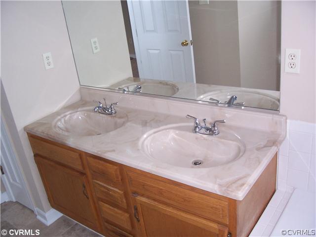 1208 Tree Ridge Road Henrico, VA 23231 - Photo 15 of 21 a bathroom with double vanity sinks and a mirror