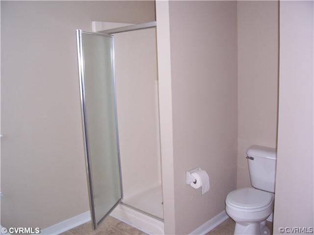 1208 Tree Ridge Road Henrico, VA 23231 - Photo 16 of 21 a bathroom with a granite countertop toilet and a shower