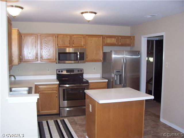 1208 Tree Ridge Road Henrico, VA 23231 - Photo 8 of 21 a kitchen with a refrigerator stove and microwave