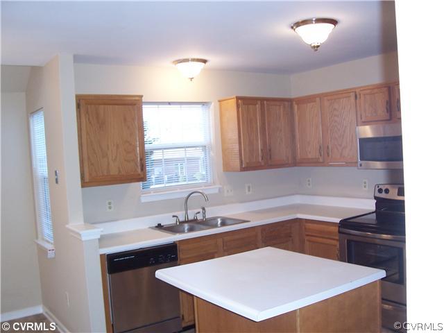 1208 Tree Ridge Road Henrico, VA 23231 - Photo 9 of 21 a kitchen with a sink a window and cabinets