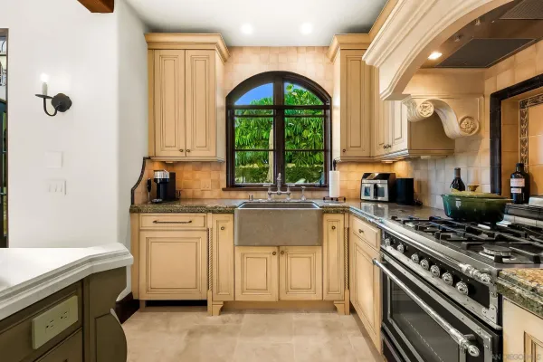 a living room with fireplace furniture and a large window