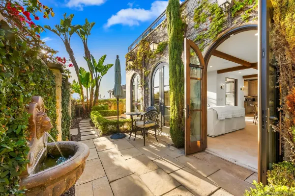a patio with a table and chairs under an umbrella