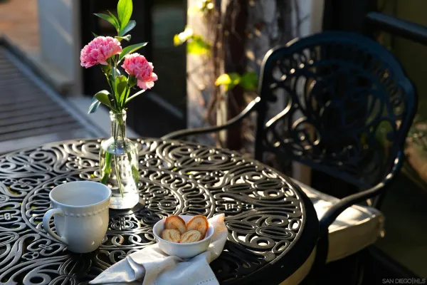 a view of a patio with couches fire pit and a dining table and chairs
