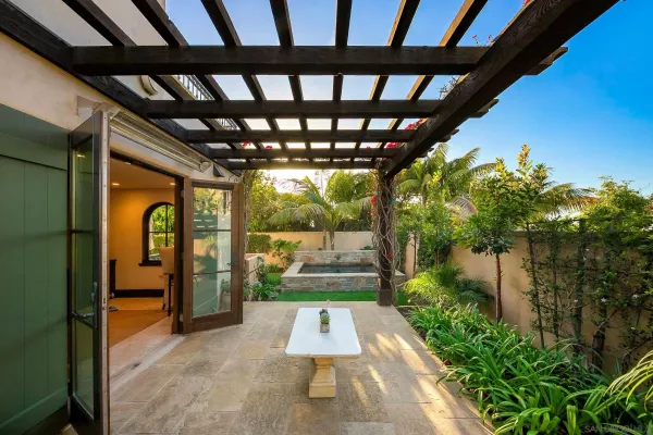 a bedroom with a bed and a flat tv screen on dresser