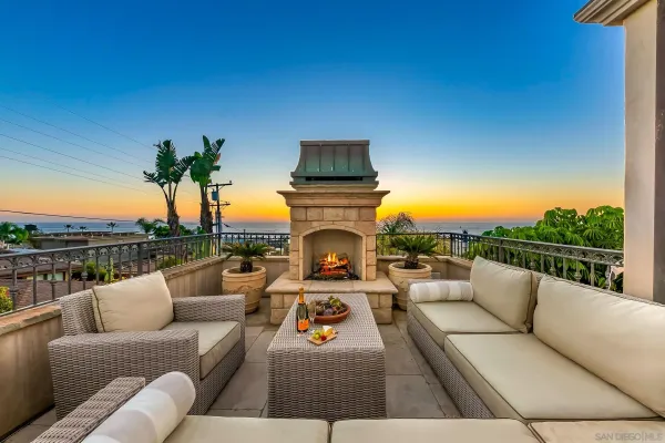 a view of a backyard with a fountain plants and large tree