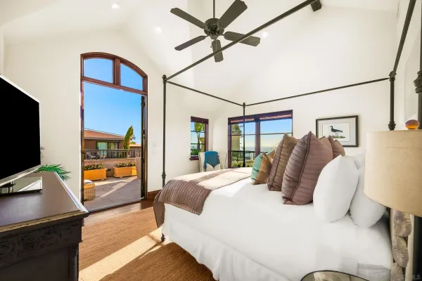 a bed room with a bed and painting on the wall