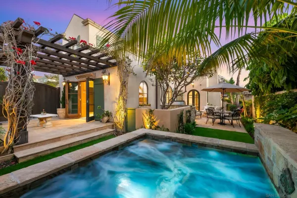 a dining hall with stainless steel appliances a sink and a large window with wooden floor