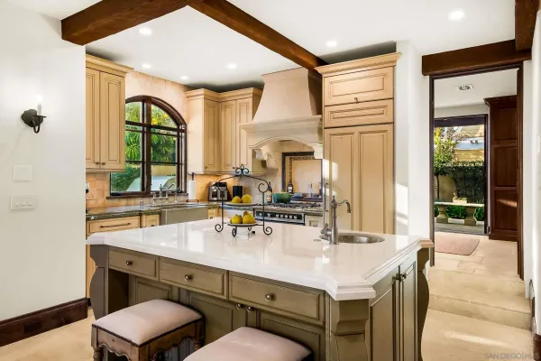 a large white kitchen with a large window