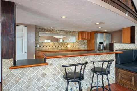 a view of a kitchen with a dining table chairs and wooden floor