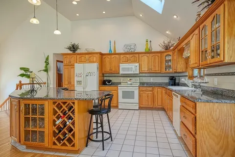 a kitchen with stainless steel appliances granite countertop a sink and cabinets