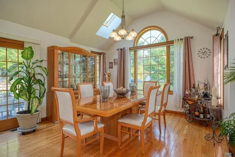 a view of a dining room with furniture window and wooden floor