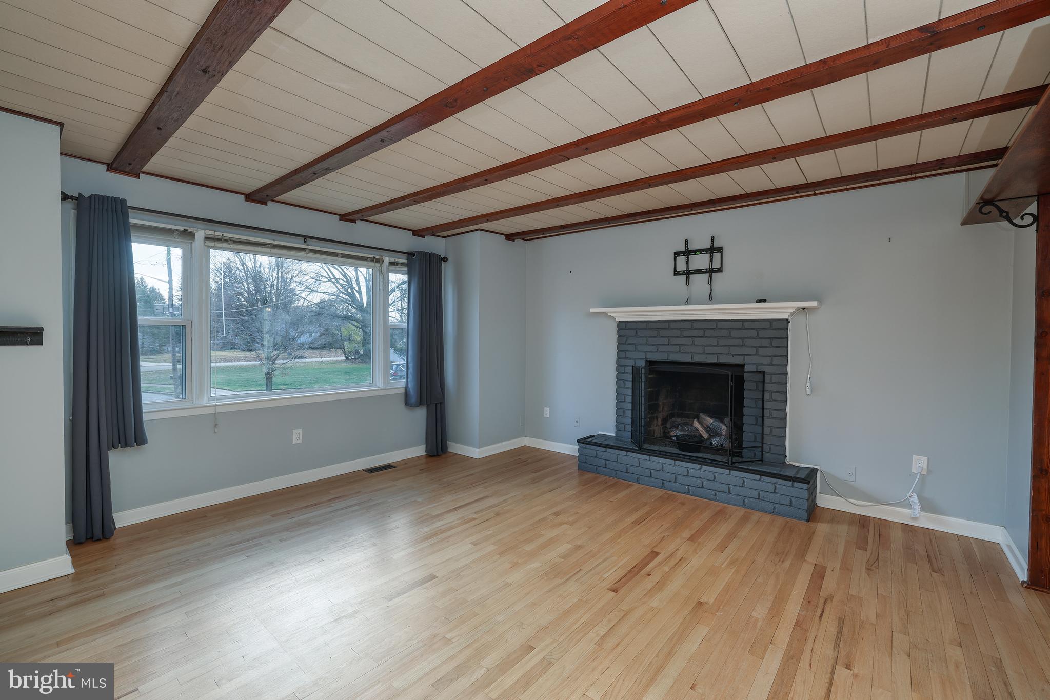 6 Van Gogh Court Ewing, NJ 08618 - Photo 2 of 25 a view of an empty room with wooden floor fireplace and a window