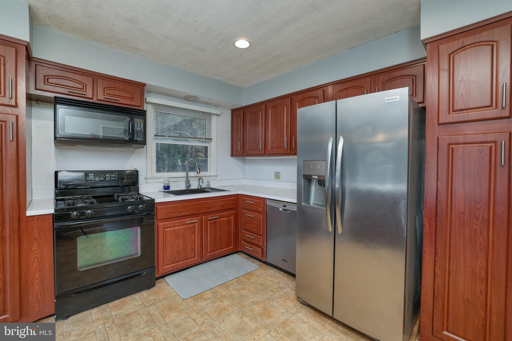 6 Van Gogh Court Ewing, NJ 08618 - Photo 5 of 25 a kitchen with stainless steel appliances granite countertop a refrigerator stove and sink